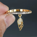 Ring with angel wing pendant gold