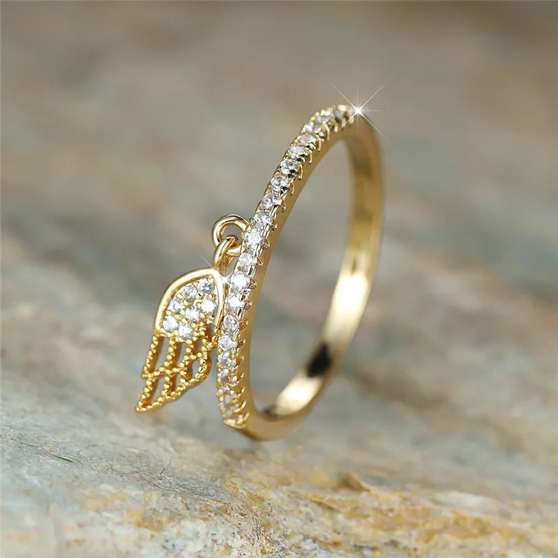 Ring with angel wing pendant gold