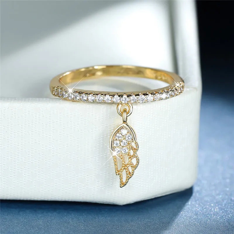Ring with angel wing pendant gold