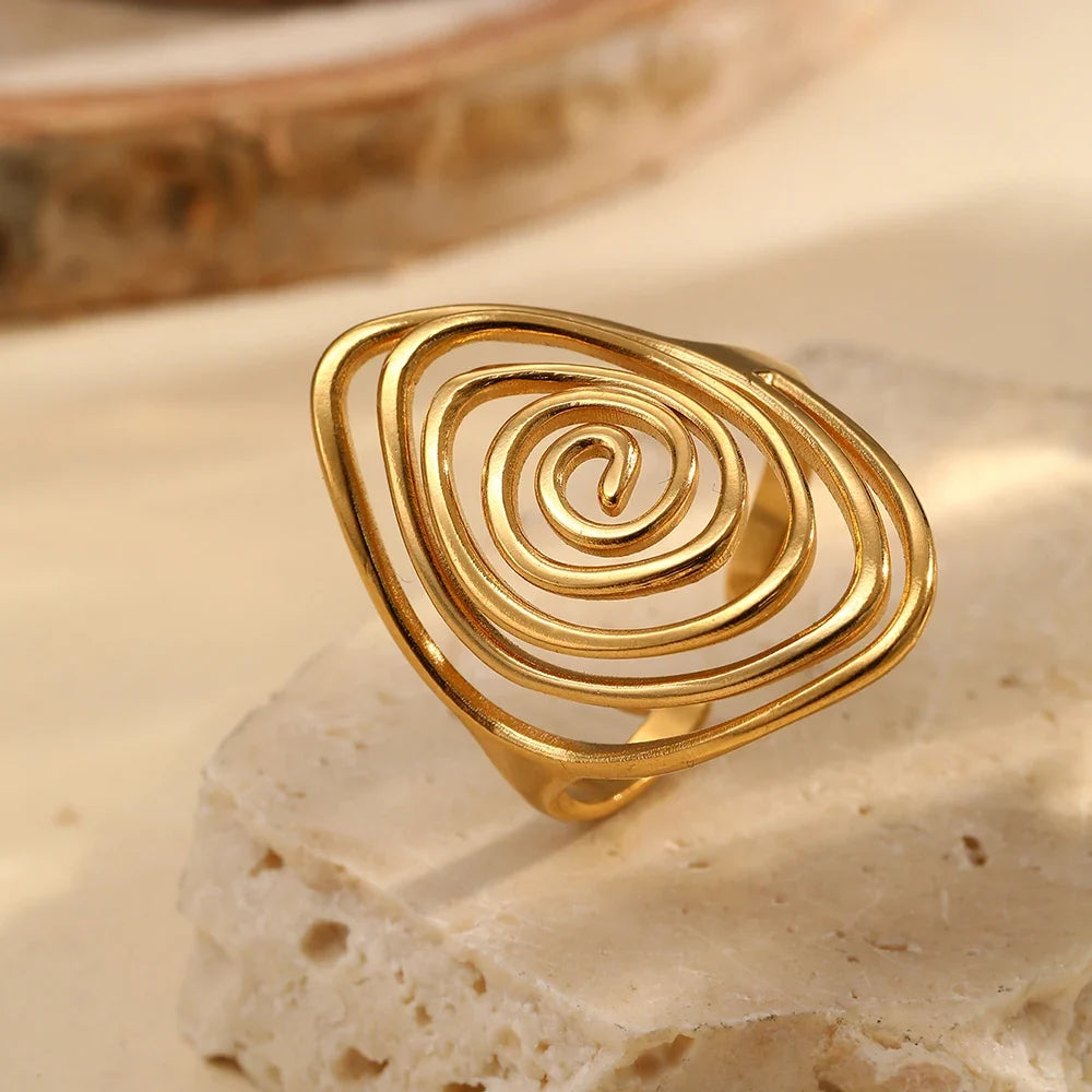Wide textured spiral ring in gold