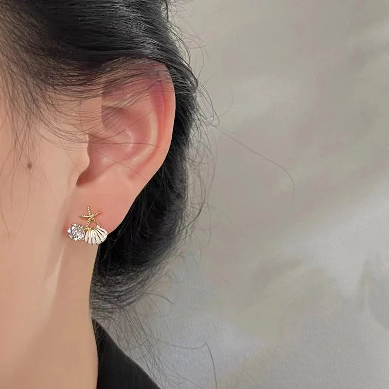 Asymmetrical white shell earrings