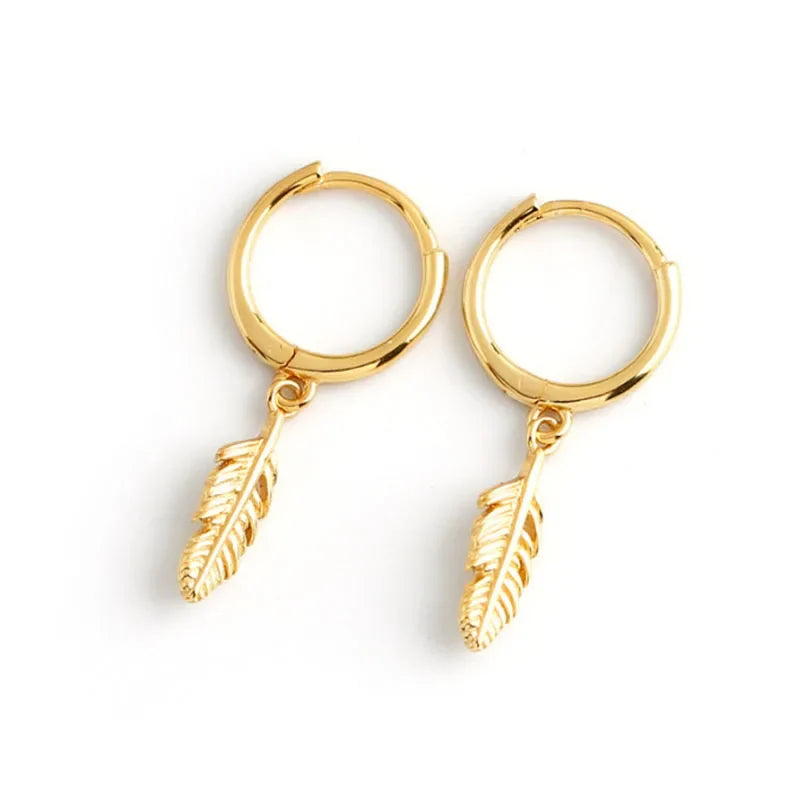 Gold hoop earrings with a small dangling feather