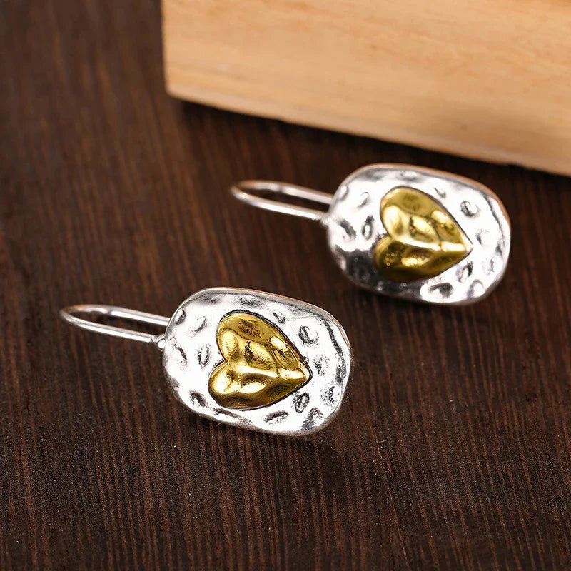 Heart-shaped earrings in silver and gold tones