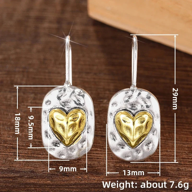 Heart-shaped earrings in silver and gold tones