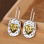 Heart-shaped earrings in silver and gold tones