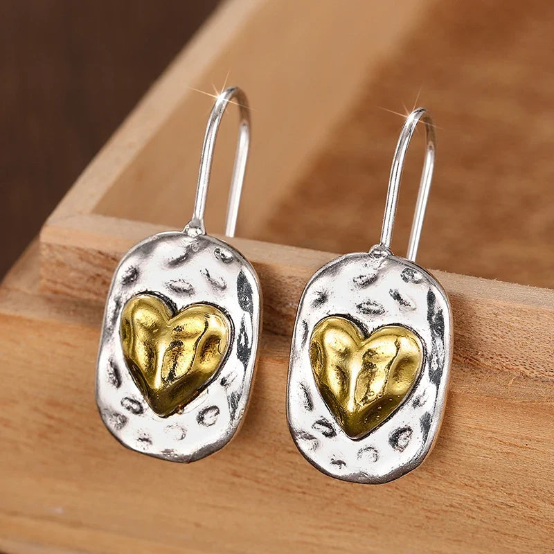 Heart-shaped earrings in silver and gold tones