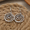 Dangling earrings with a chiseled spiral