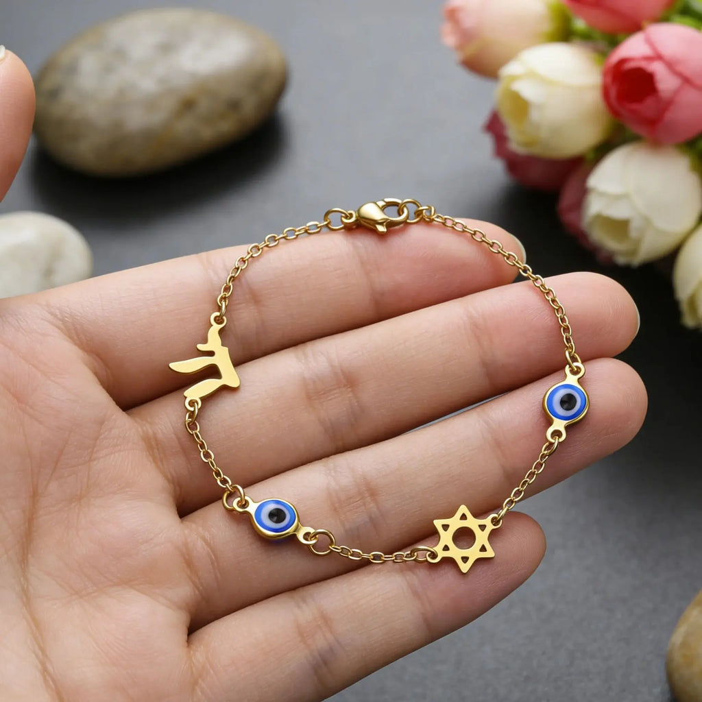 Bracelet with protective symbols: blue eye, Chai, and the Star of David in gold