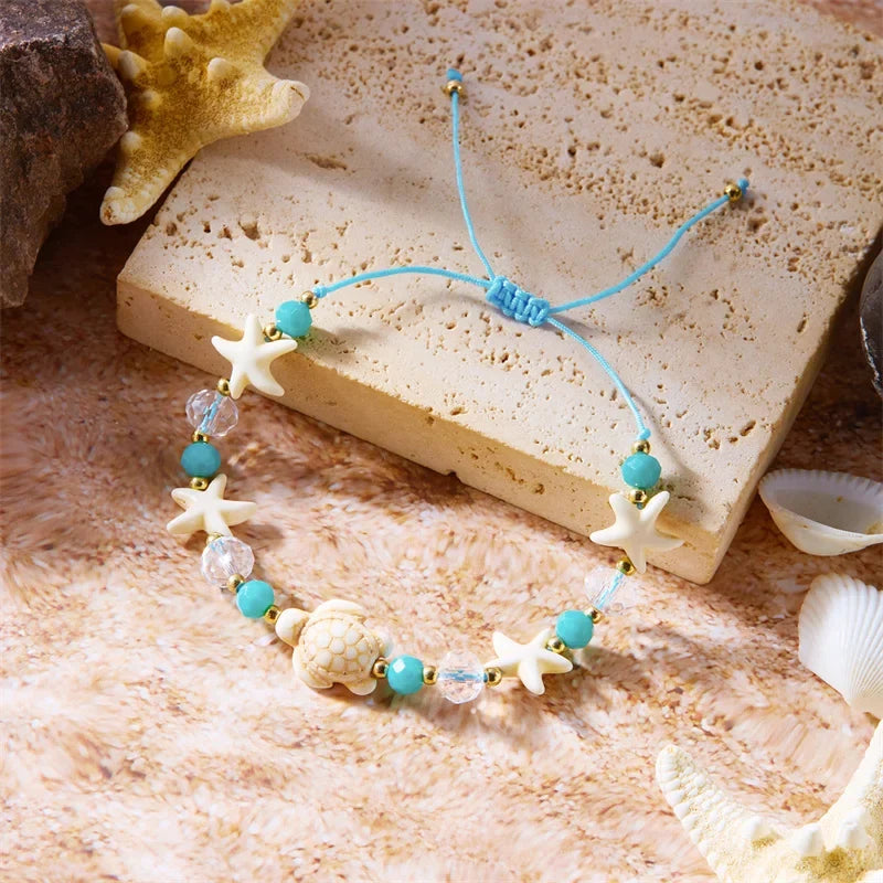 Cord bracelet with shell and blue starfish turtle