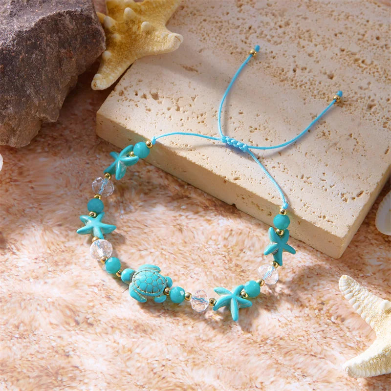 Cord bracelet with shell and blue starfish turtle