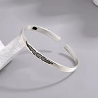 Open bangle bracelet with silver-tone feather