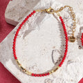 Coral red and gold bracelet