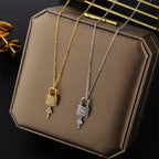 Necklace with key and lock pendant in gold
