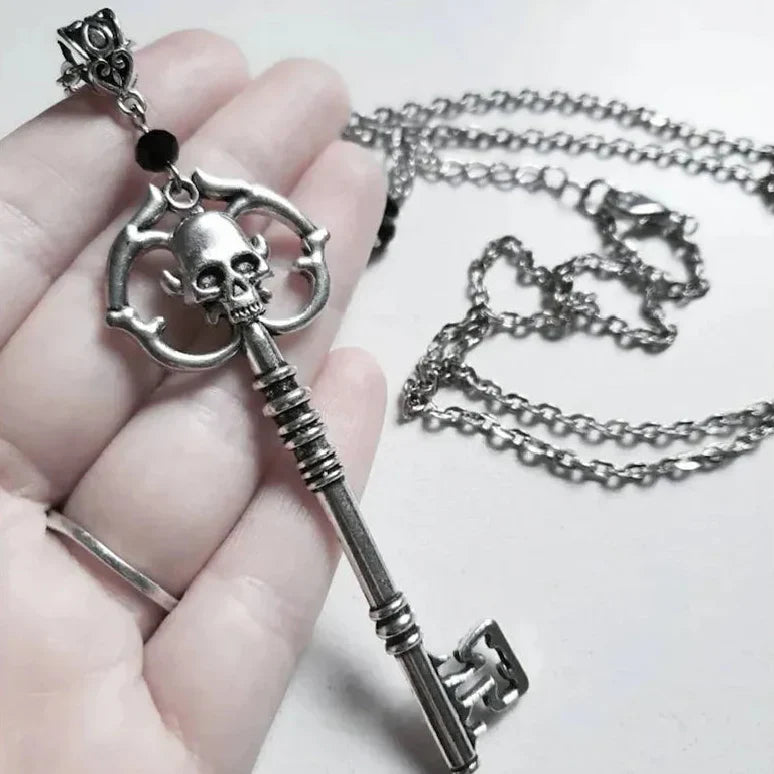 Necklace with key and skull pendant