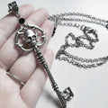 Necklace with key and skull pendant