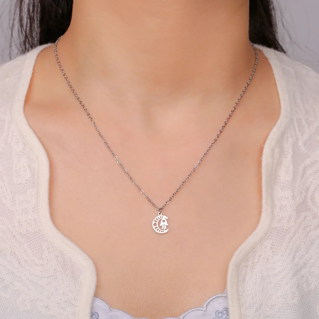 Necklace with Arabic Islamic crescent moon and Hamsa pendant in silver