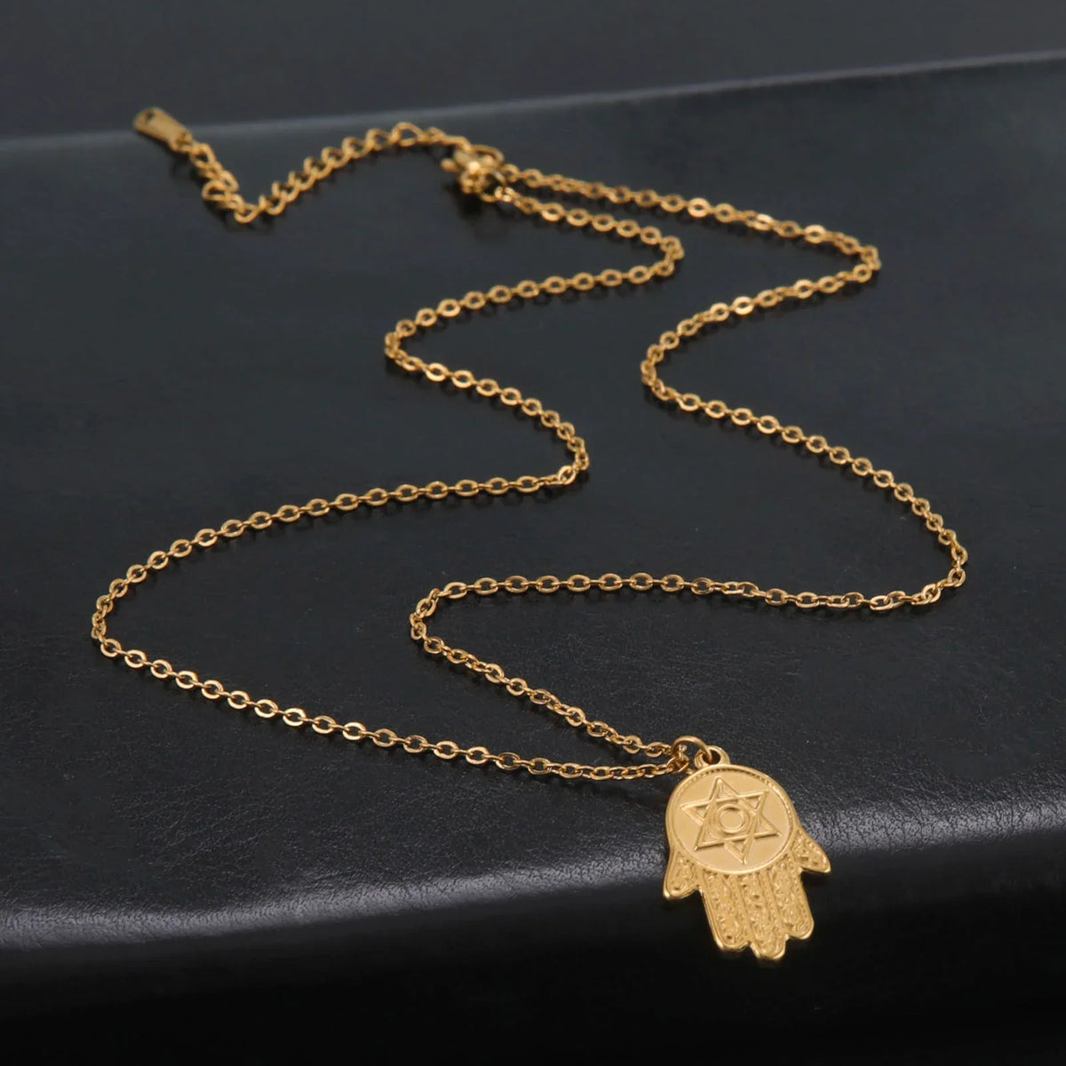 Necklace with protective pendant featuring the Star of David and Hamsa in gold