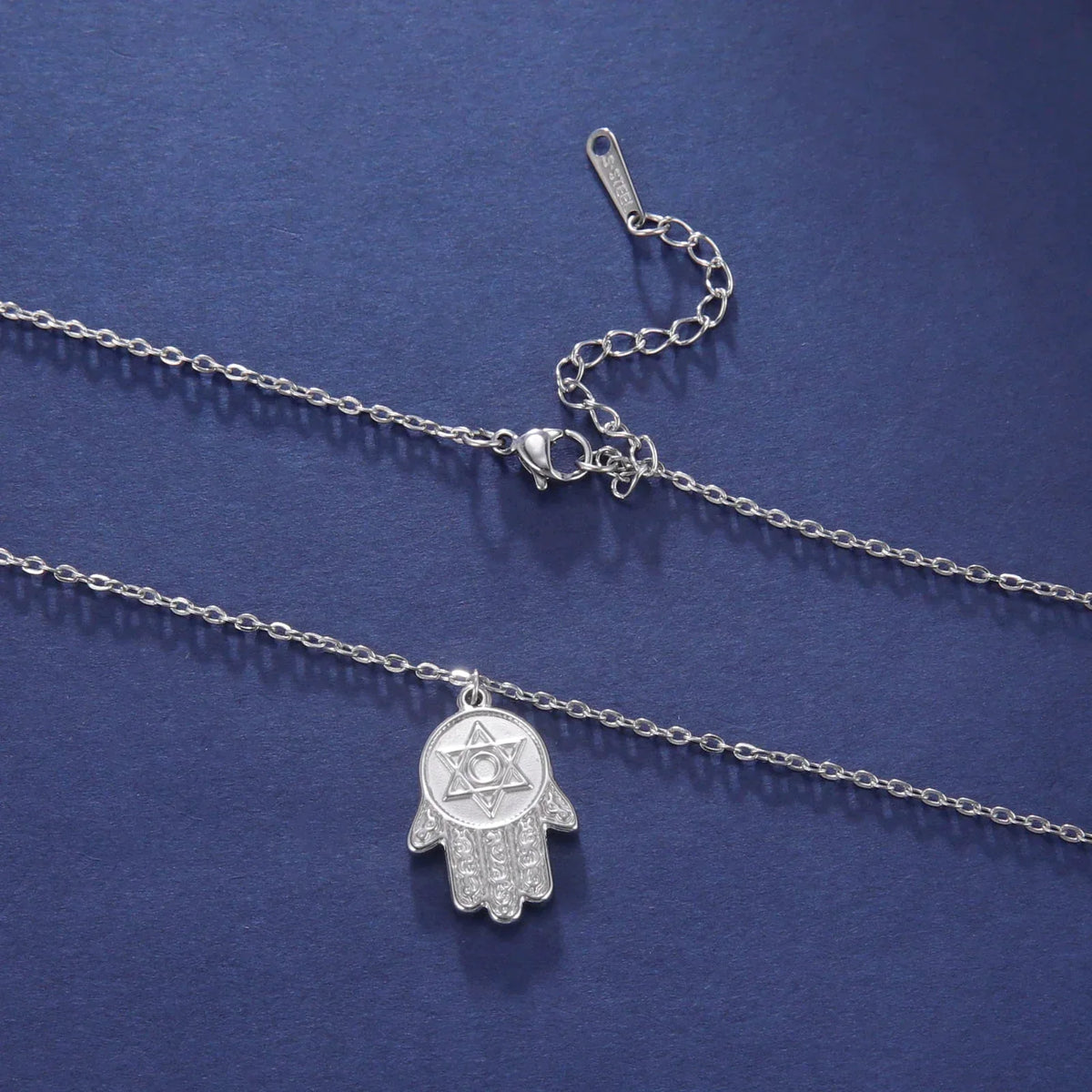 Necklace with protective pendant featuring the Star of David and Hamsa in silver
