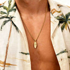 Necklace with small palm tree and sea pendant in gold