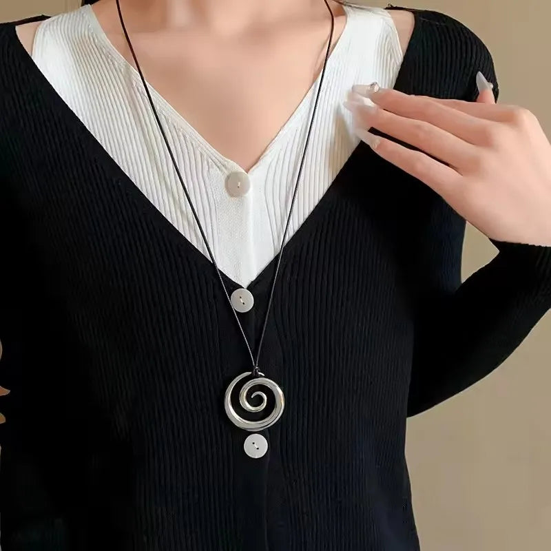 Long necklace with silver-toned spiral pendant