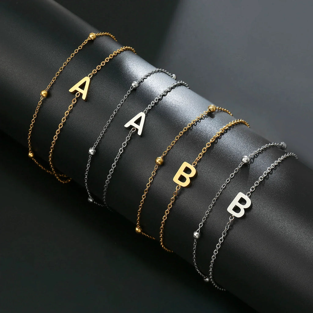 Double initial bracelet in gold and silver