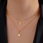 Double necklace with key and lock pendant in gold