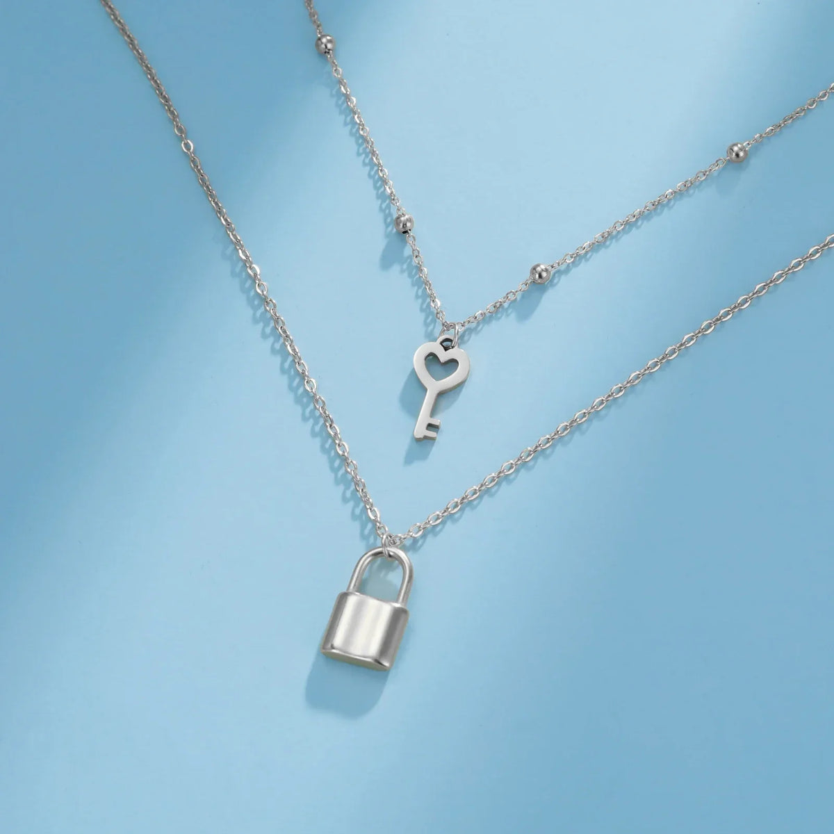 Double necklace with key and lock pendant in silver