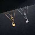Double necklace with key and lock pendant in gold