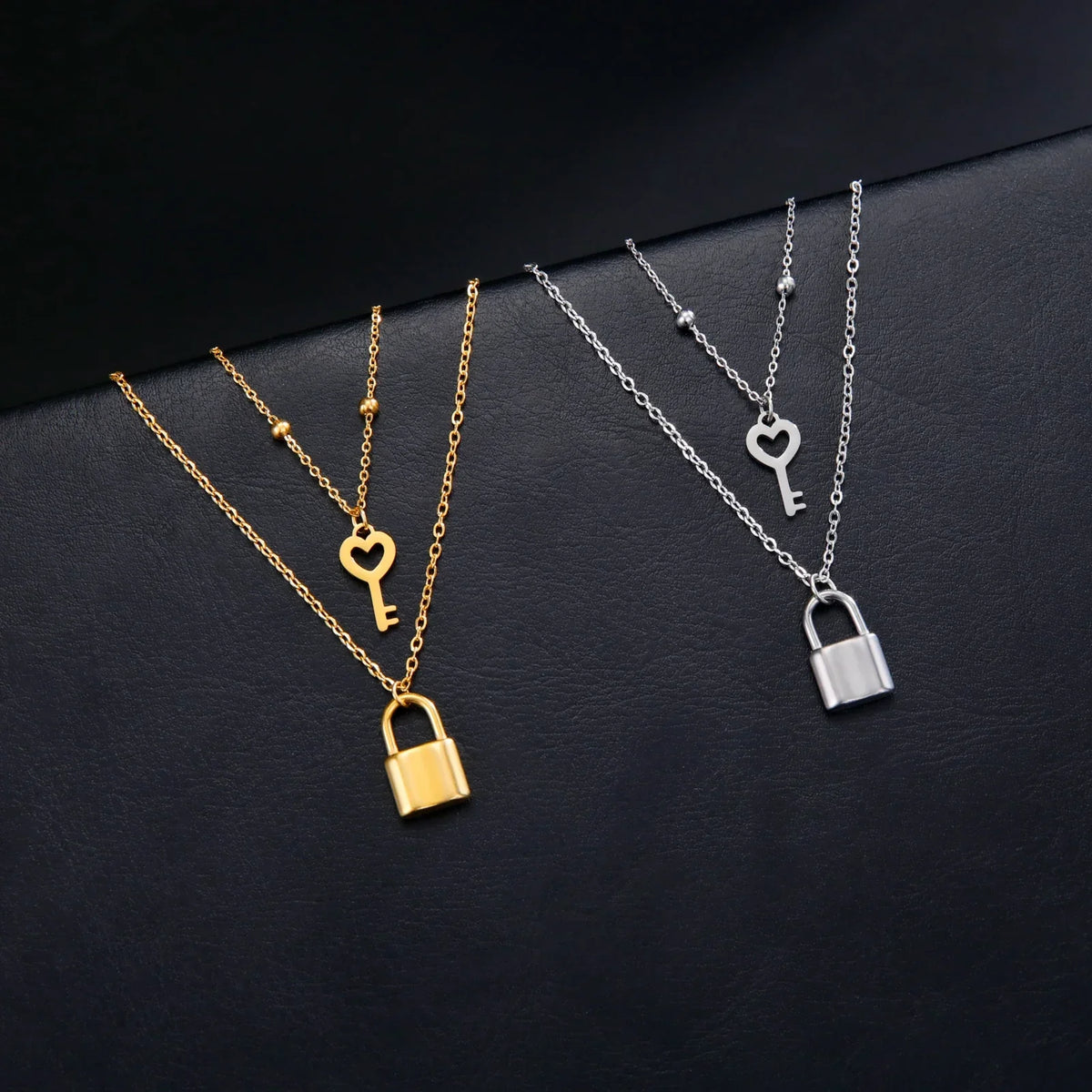 Double necklace with key and lock pendant in gold