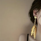 Large gold feather earrings