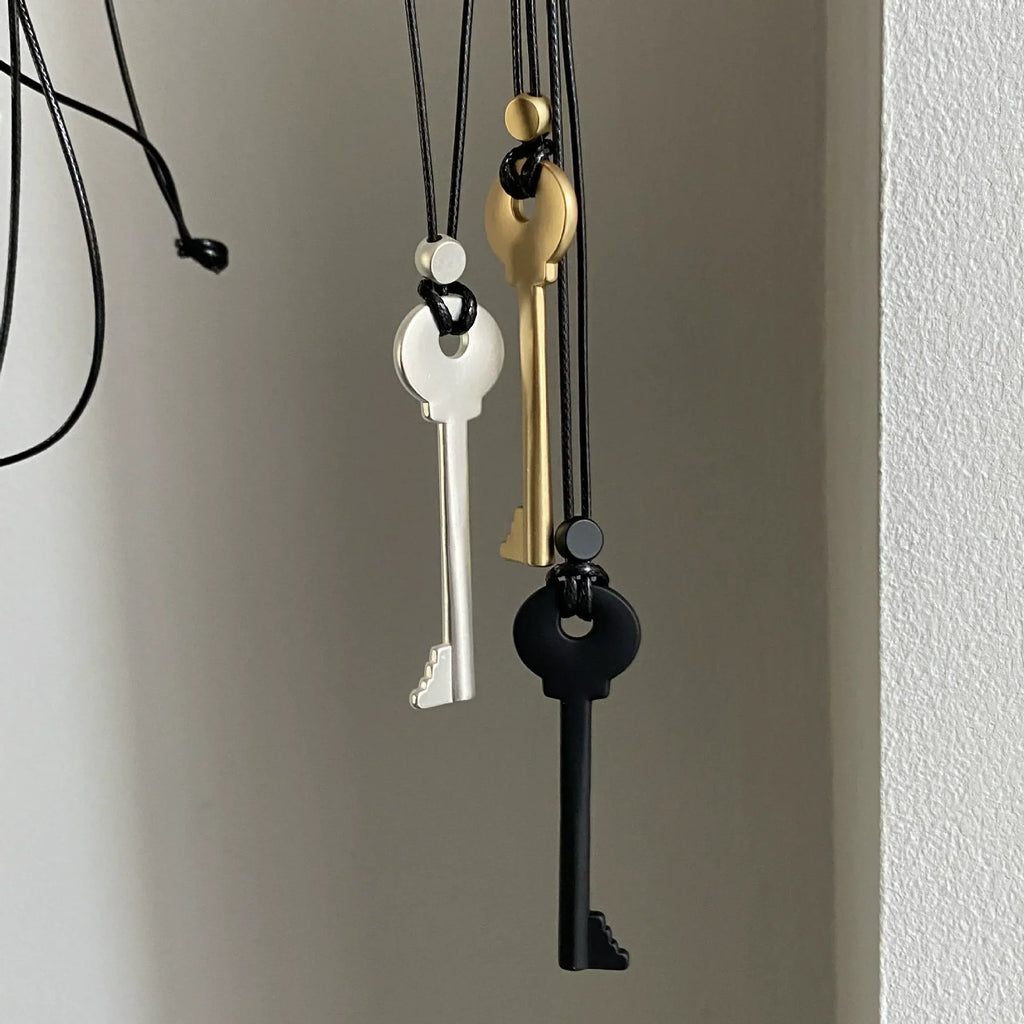 Long cord necklace with black key pendant
