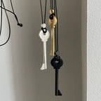 Long cord necklace with black key pendant