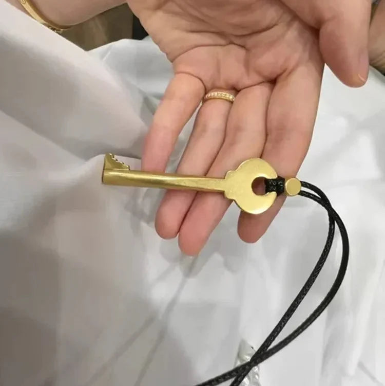 Long cord necklace with gold key pendant