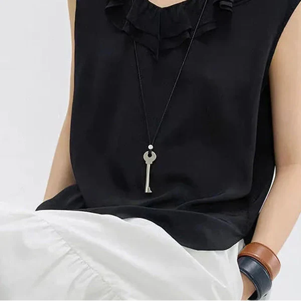 Long cord necklace with matte silver key pendant