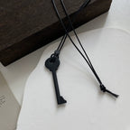 Long cord necklace with black key pendant