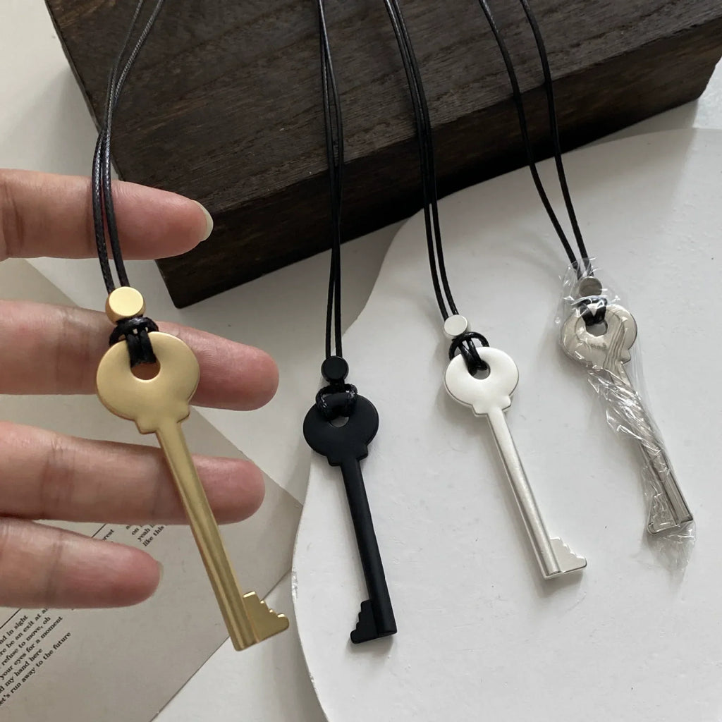 Long cord necklace with gold key pendant
