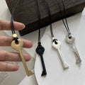 Long cord necklace with gold key pendant