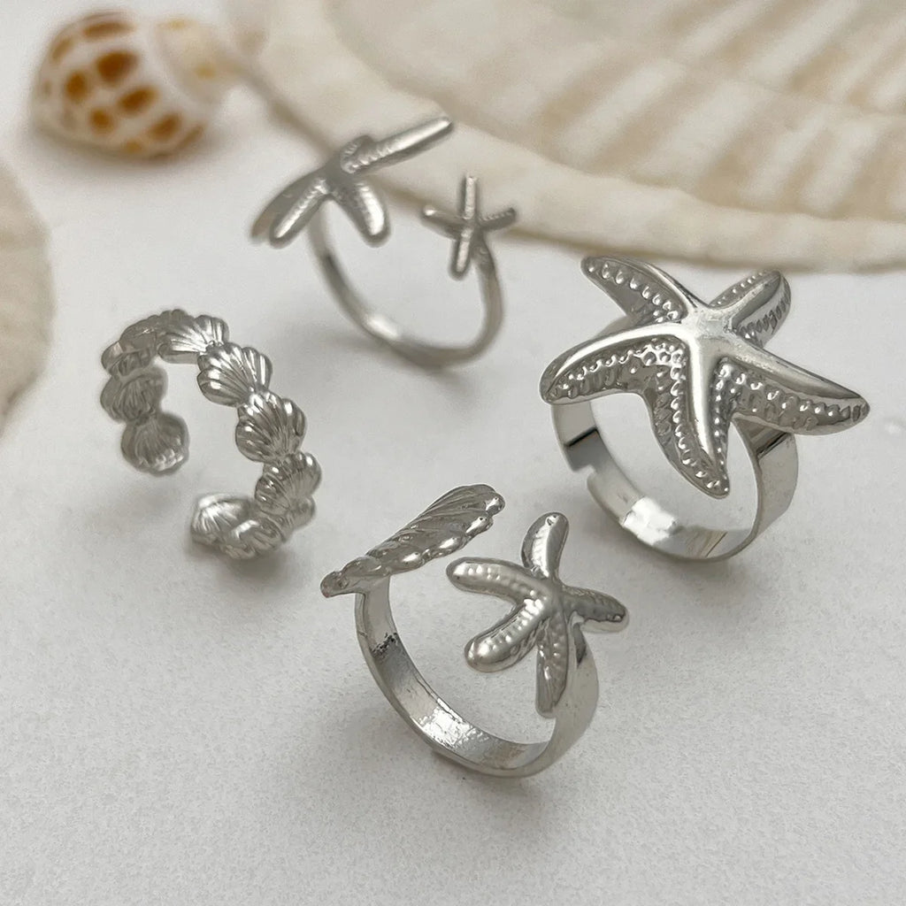 Set of 4 shell and starfish rings silver