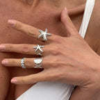 Set of 4 shell and starfish rings silver