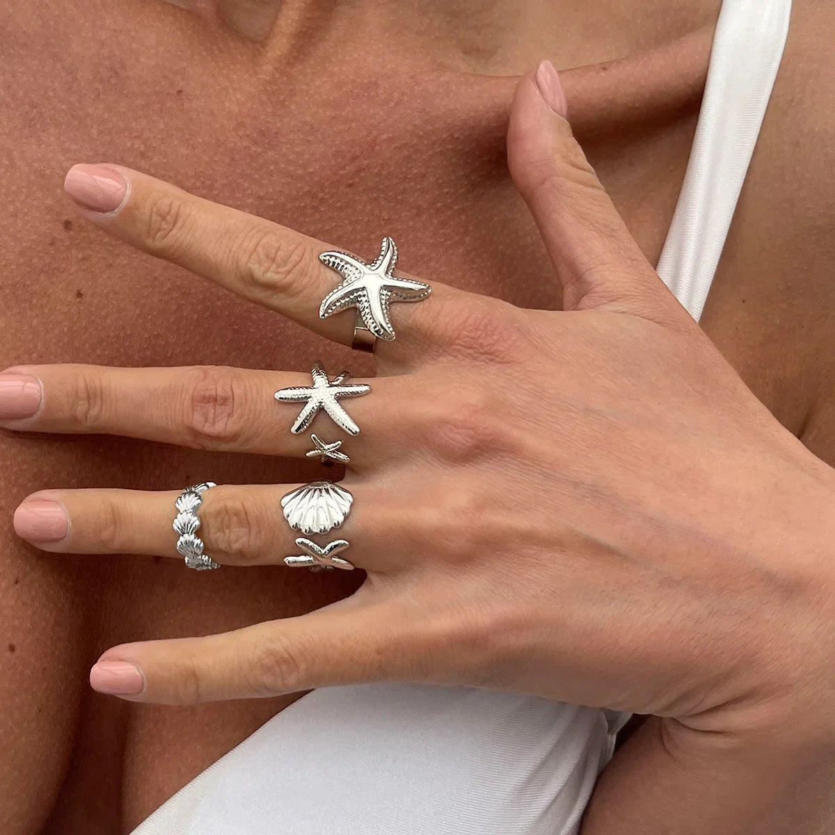 Set of 4 shell and starfish rings silver