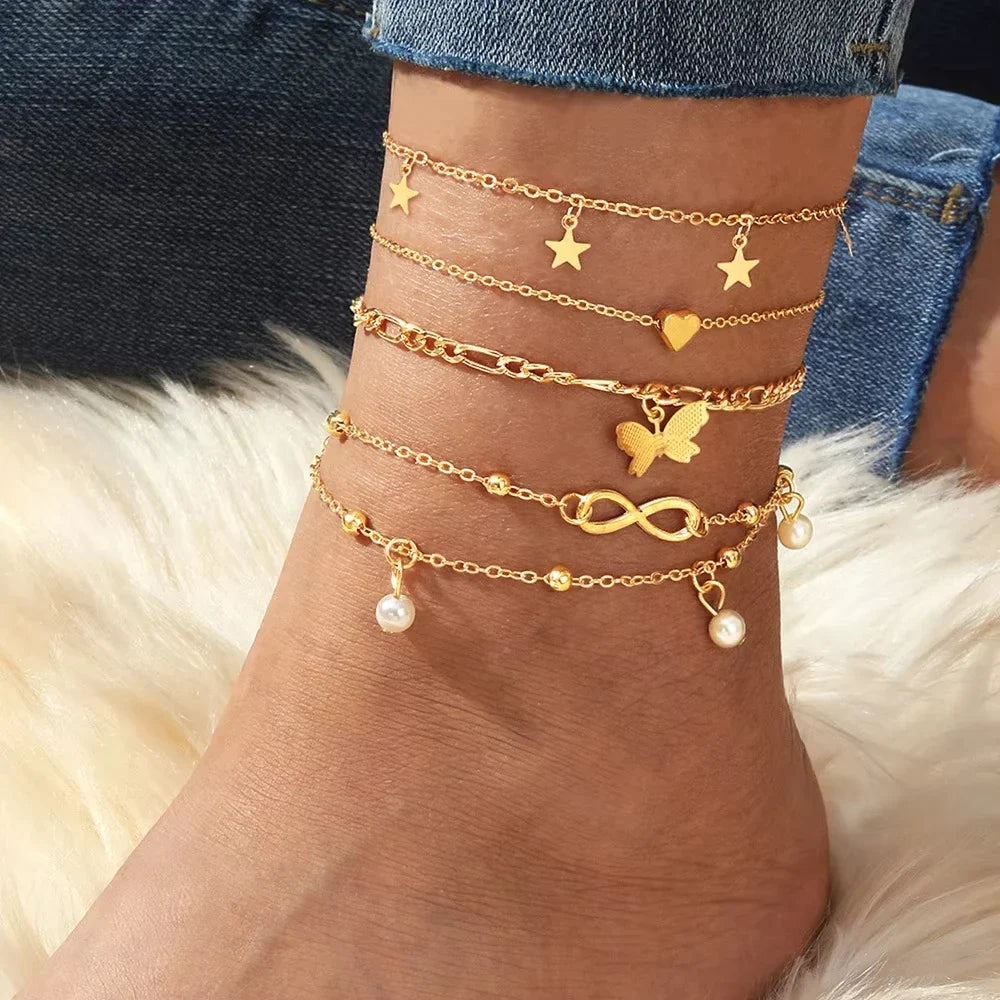 Set of 5 anklets: star, infinity, butterfly, beads, and heart
